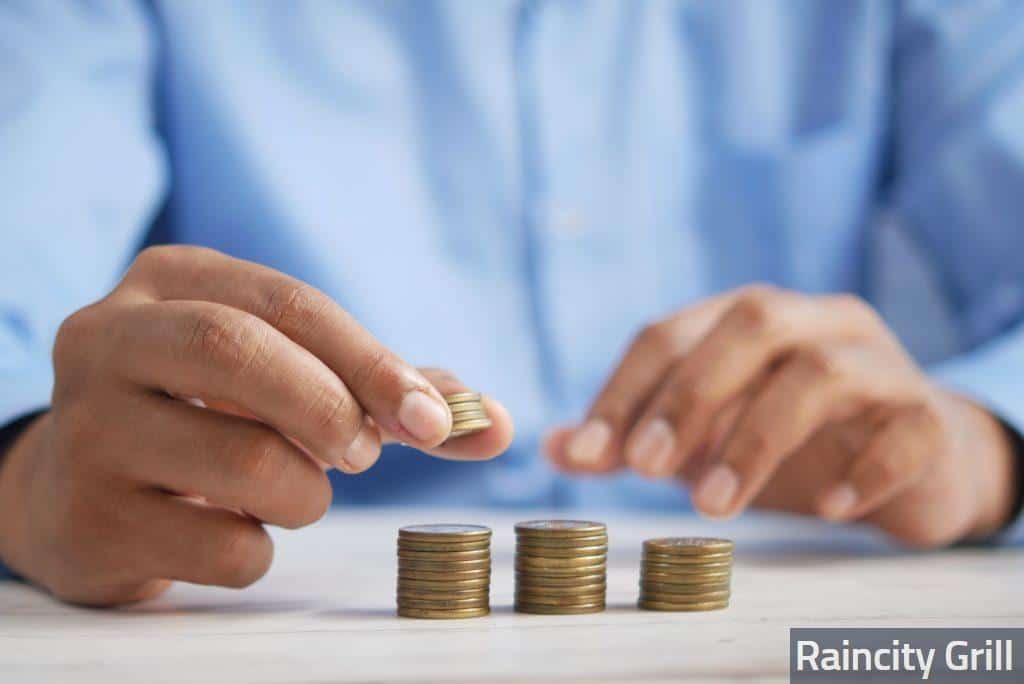 a person stacking coins on top of a table