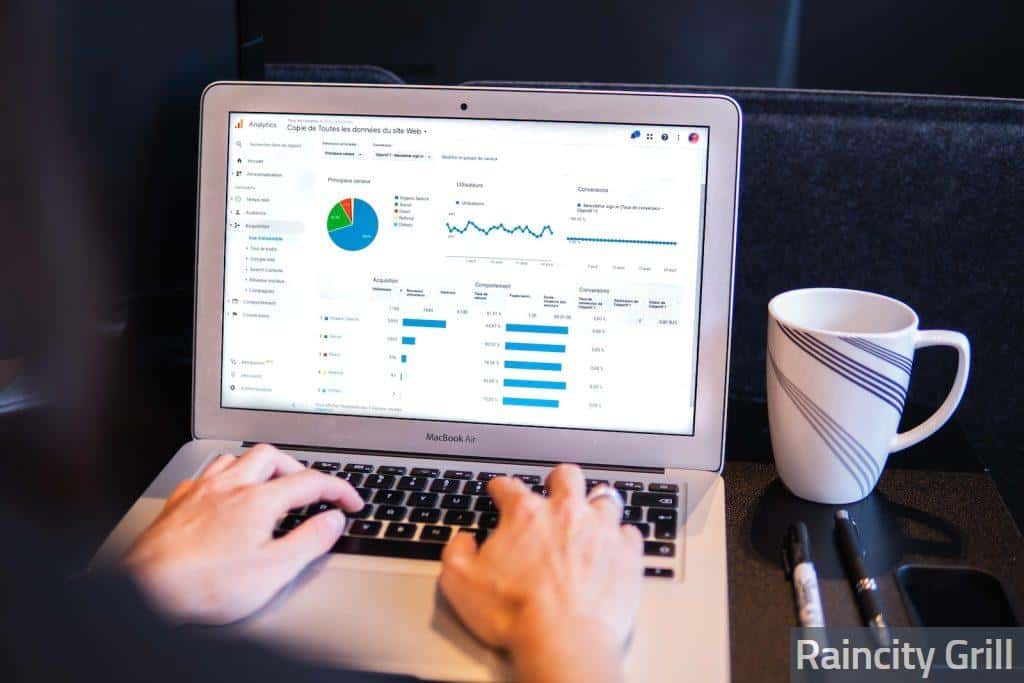 person using macbook pro on black table